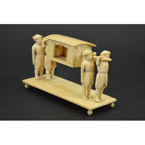 27 - λ A 19th century Indian ivory figure group of a palanquin being carried by four men, 15cm long, 8cm ... 