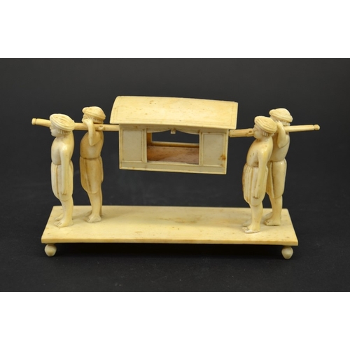 27 - λ A 19th century Indian ivory figure group of a palanquin being carried by four men, 15cm long, 8cm ... 