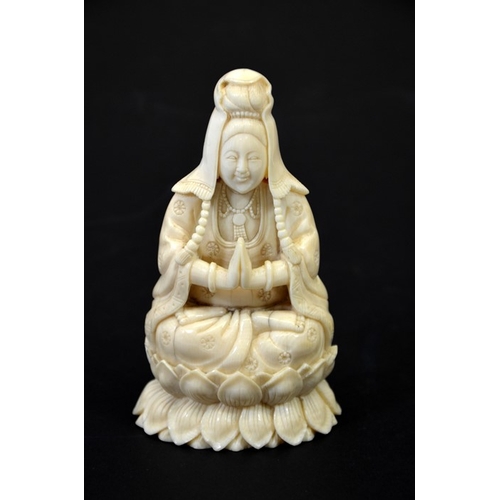 30 - λ A Chinese carved ivory figure of Guanyin, circa 1900, seated Buddhist pose, on lotus leaf, 13cm hi... 