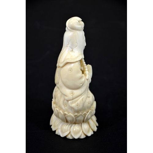 30 - λ A Chinese carved ivory figure of Guanyin, circa 1900, seated Buddhist pose, on lotus leaf, 13cm hi... 