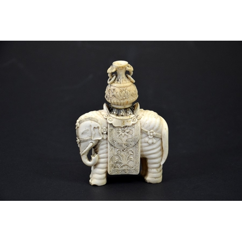 31 - λ A 19th century Chinese carved ivory figure of an elephant with vase on its back, decorated with fl... 