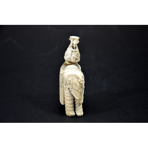 31 - λ A 19th century Chinese carved ivory figure of an elephant with vase on its back, decorated with fl... 