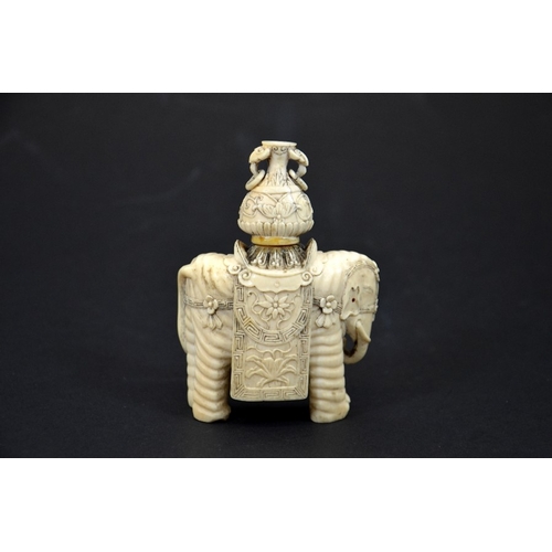 31 - λ A 19th century Chinese carved ivory figure of an elephant with vase on its back, decorated with fl... 