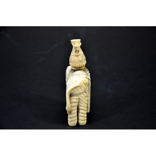 31 - λ A 19th century Chinese carved ivory figure of an elephant with vase on its back, decorated with fl... 