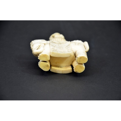 31 - λ A 19th century Chinese carved ivory figure of an elephant with vase on its back, decorated with fl... 