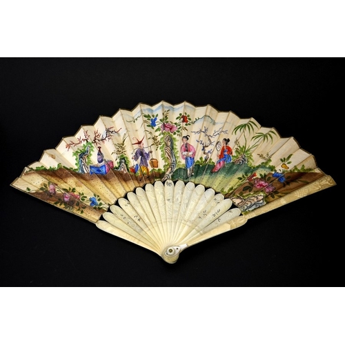 35 - λ An 18th century Chinese carved ivory and painted fan, circa 1750, the front guard carved in relief... 