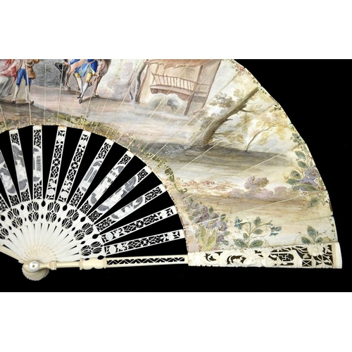 44 - λ An 18th century ivory fan, with elaborately carved and pierced Chinoiserie guards and sticks, the ... 