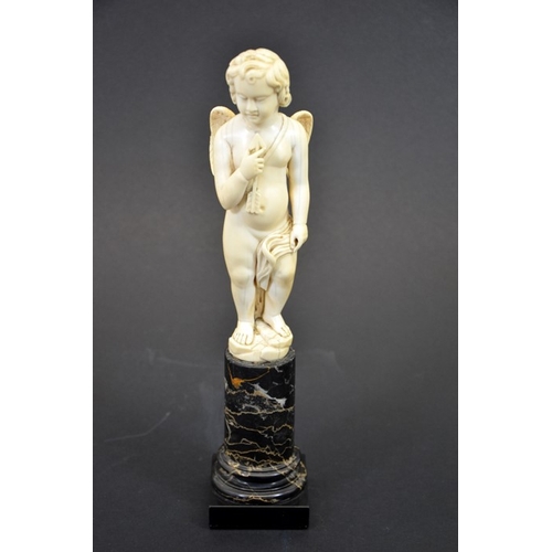 51 - A 19th century Dieppe carved ivory figure of Cupid, on marble plinth, 28cm high