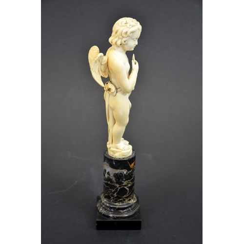 51 - A 19th century Dieppe carved ivory figure of Cupid, on marble plinth, 28cm high