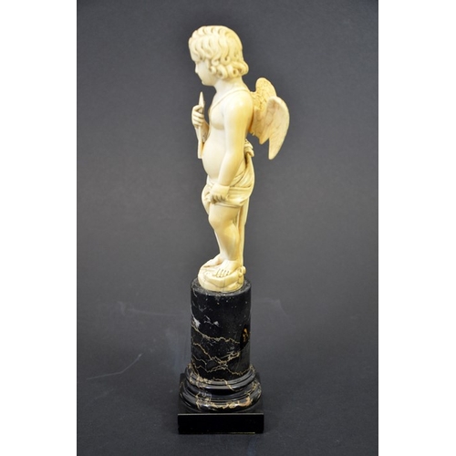 51 - A 19th century Dieppe carved ivory figure of Cupid, on marble plinth, 28cm high