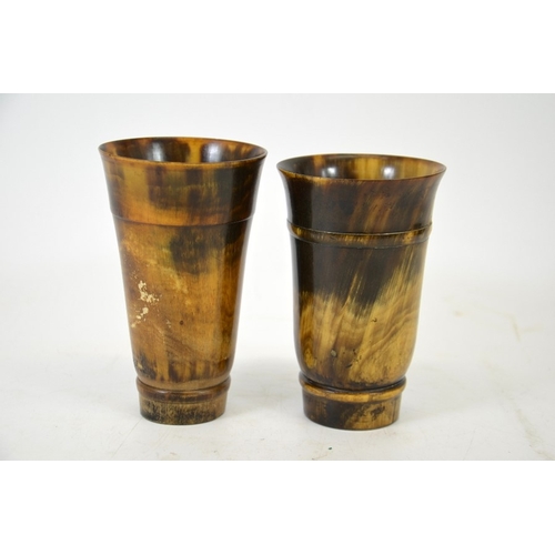 57 - Two 19th century turned horn beakers, one with a glass bottom, each with carved banding, 12.5cm high... 