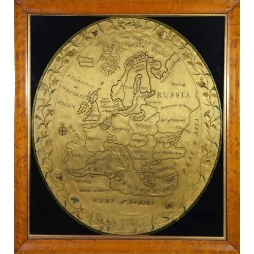 63 - An 18th century silk embroidered map of Europe, circa 1770, oval, within a floral vine border, 50cm ... 