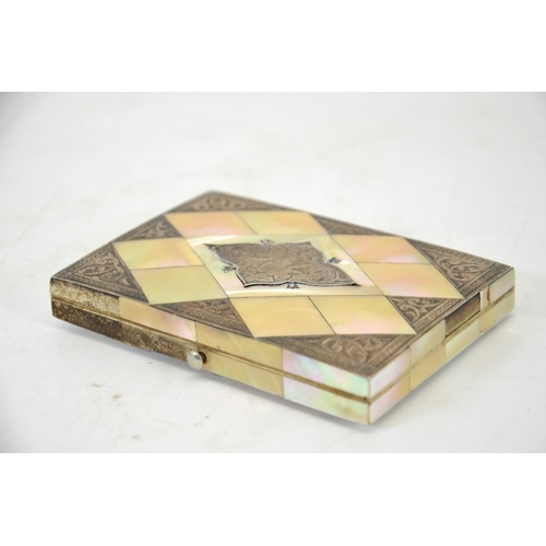 76 - A Victorian mother of pearl and silver card case, chased cartouche and corners, opening to reveal a ... 