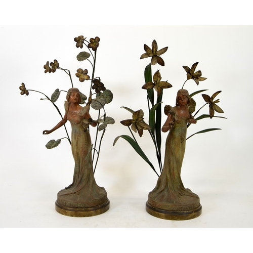 82 - A pair of French Art Nouveau bronzed and painted figures, La Violette and L'Orchidee, modelled as fe... 