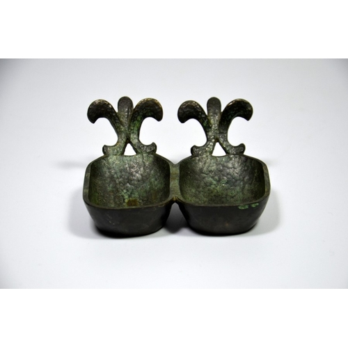 86 - Six pieces of Palestinian bronze including two bowls, a pair of candlesticks, a box and a double dis... 