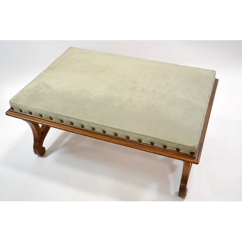 117 - A large Regency walnut footstool, in the manner of Thomas Hope, supported on lyre shaped ends united... 