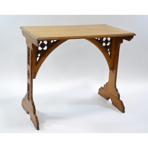 131 - A W N Pugin (attributed), a Gothic Revival oak side table, the two trestle supports carved with ivy ... 