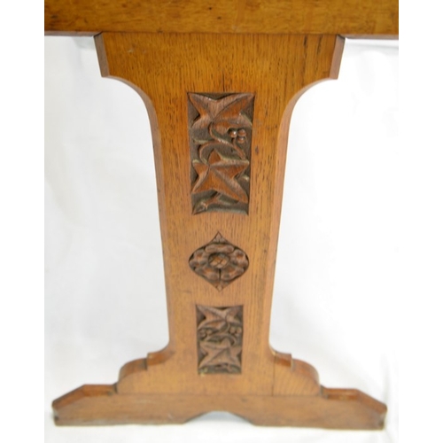 131 - A W N Pugin (attributed), a Gothic Revival oak side table, the two trestle supports carved with ivy ... 