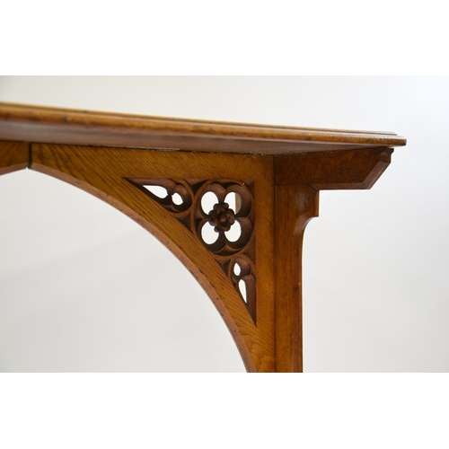 131 - A W N Pugin (attributed), a Gothic Revival oak side table, the two trestle supports carved with ivy ... 