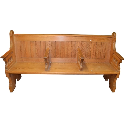 133 - A Gothic Revival pine three seat pew, each arm pierced with trefoil roundels, 183cm long