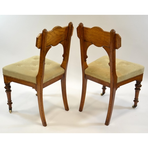 134 - A pair of Gothic Revival oak chairs, circa 1860, the backs with convex roundel and moulded screw cap... 