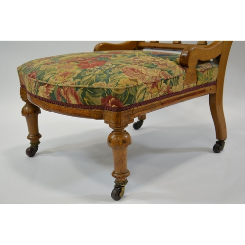 140 - Charles Bevan (attributed), a Gothic Revival oak easy chair, the curved boat back upholstered below ... 