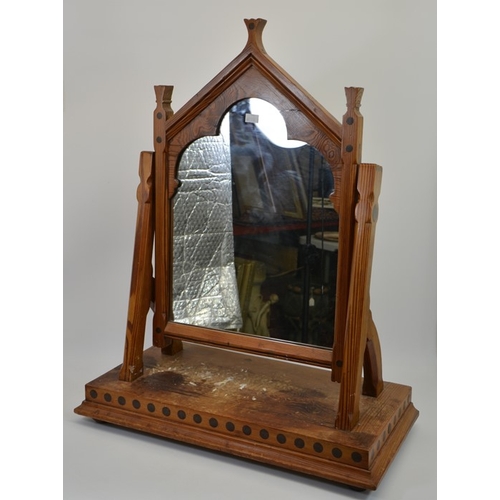 141 - Charles Bevan (attributed), a Gothic Revival pine swing toilet mirror, the triangular arched frame w... 