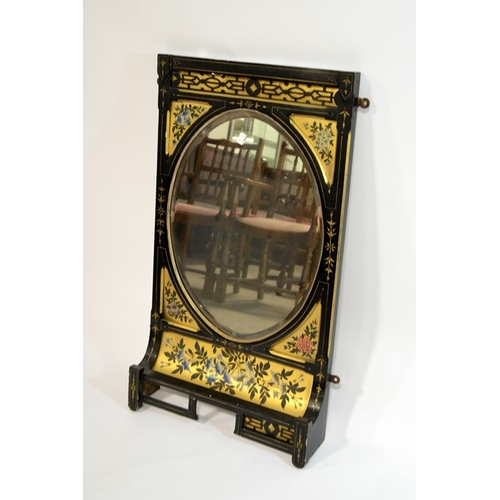 146 - An Aesthetic Movement ebonised mirror, circa 1880, painted with gilt backed floral motifs and blind ... 