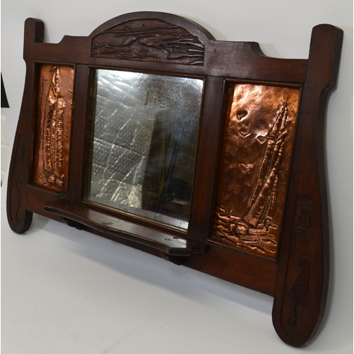 152 - An Arts and Crafts mahogany wall mounted mirror, flanked by repousse copper panels depicting sailing... 