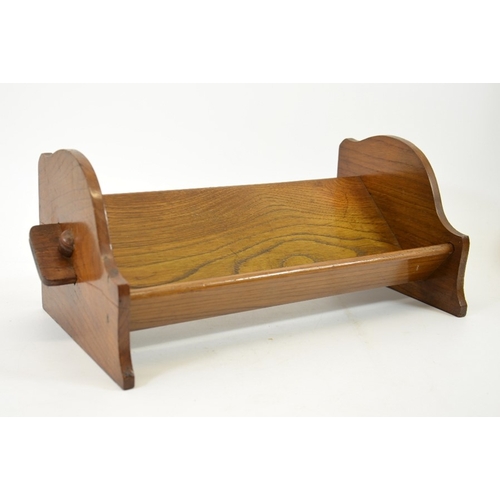 153 - An Arts and Crafts peg jointed oak book trough, 43cm wide