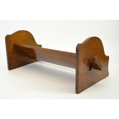 153 - An Arts and Crafts peg jointed oak book trough, 43cm wide