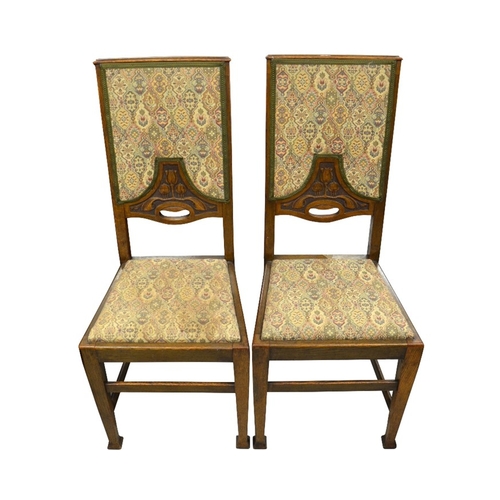 161 - A set of four Arts and Crafts oak dining chairs, upholstered seats and backs carved with tulip motif... 