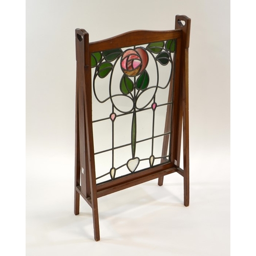 163 - Liberty and Co., an Arts and Crafts mahogany and stained glass fire screen, in the Glasgow style, th... 