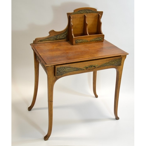 171 - An Art Nouveau writing desk, circa 1900, walnut, with applied repousse brass plaques, the rack with ... 