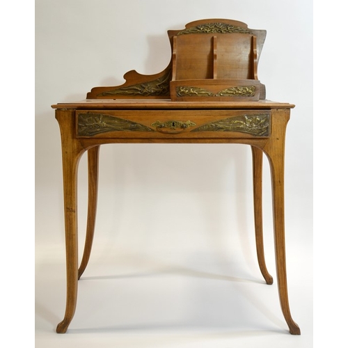 171 - An Art Nouveau writing desk, circa 1900, walnut, with applied repousse brass plaques, the rack with ... 