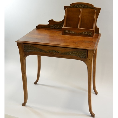 171 - An Art Nouveau writing desk, circa 1900, walnut, with applied repousse brass plaques, the rack with ... 