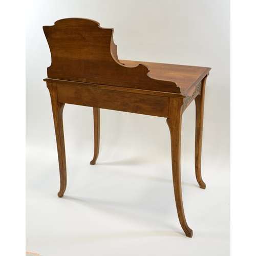 171 - An Art Nouveau writing desk, circa 1900, walnut, with applied repousse brass plaques, the rack with ... 