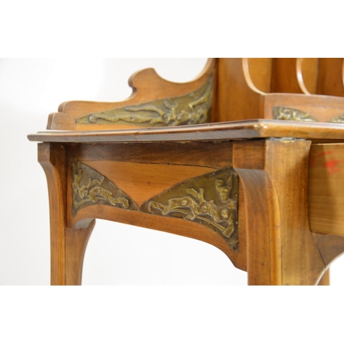 171 - An Art Nouveau writing desk, circa 1900, walnut, with applied repousse brass plaques, the rack with ... 