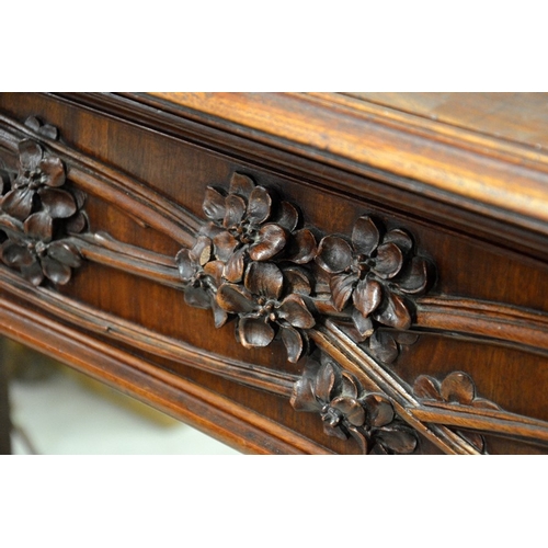 172 - Louis Majorelle (attributed), a large Art Nouveau carved walnut fire surround, circa 1900, modelled ... 