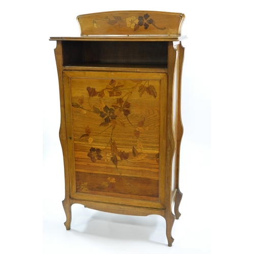 179 - Emile Galle, an Art Nouveau marquetry cabinet, circa 1900, the cupboard door inlaid with specimen wo... 