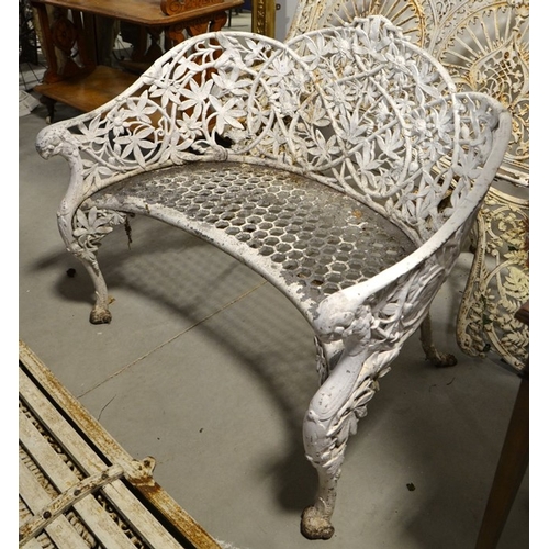 192 - After Coalbrookdale, a cast Passion Flower garden seat, tub form with cabriole front legs and owl he... 