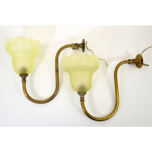 224 - A pair of Arts and Crafts brass wall lights with frosted glass shades, curved tubular arms supportin... 