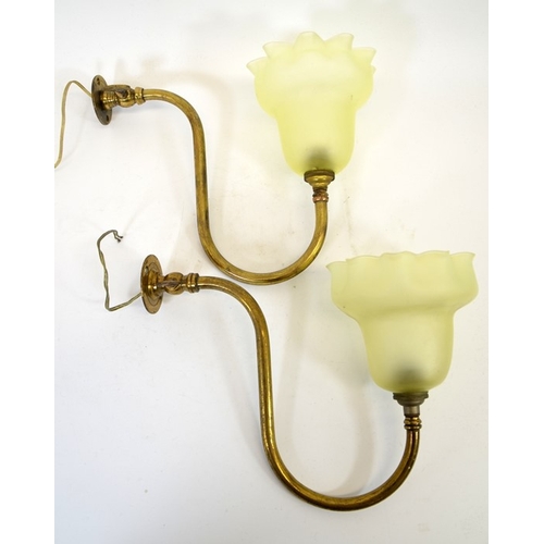 224 - A pair of Arts and Crafts brass wall lights with frosted glass shades, curved tubular arms supportin... 