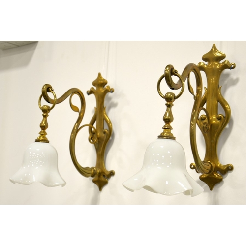 229 - A pair of Arts and Crafts brass wall mounted lights, circa 1900, cast pierced foliate and trefoil wa... 