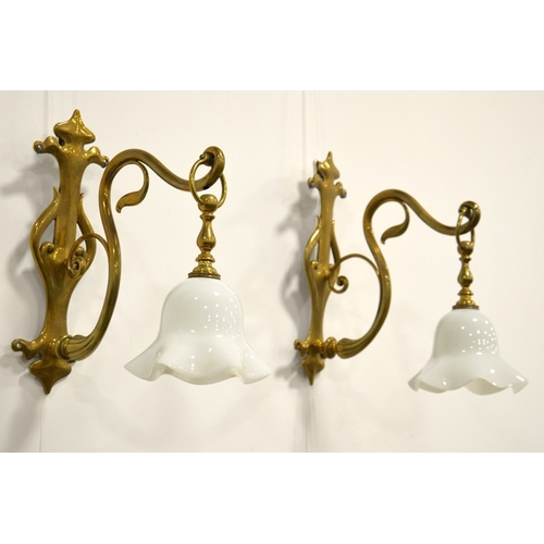 229 - A pair of Arts and Crafts brass wall mounted lights, circa 1900, cast pierced foliate and trefoil wa... 