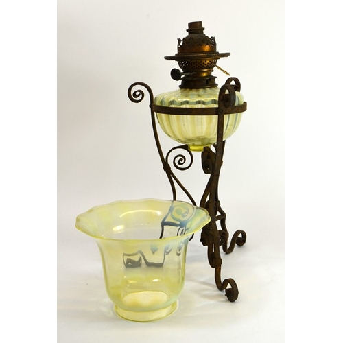 238 - James Powell and Sons, an Arts and Crafts opalescent glass and wrought iron table oil lamp, circa 18... 