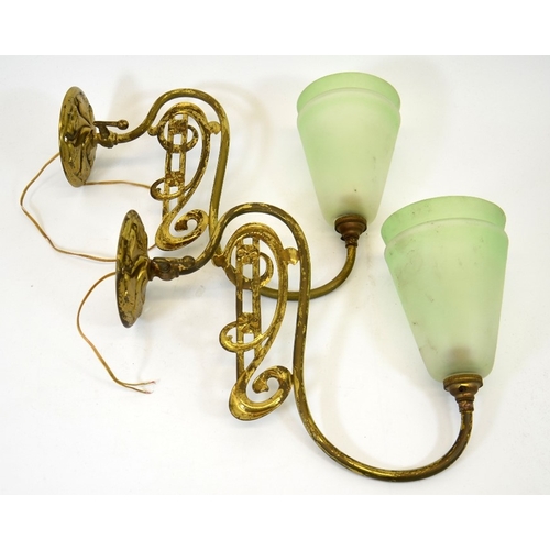 245 - A pair of Art Nouveau brass wall lights, the curved arms with C scroll and bar open decoration, with... 