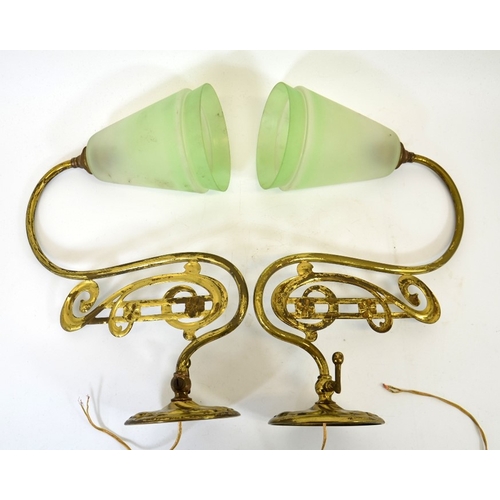 245 - A pair of Art Nouveau brass wall lights, the curved arms with C scroll and bar open decoration, with... 