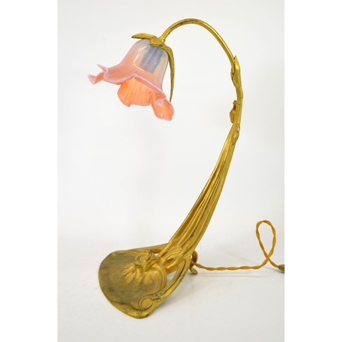 248 - An Art Nouveau gilt bronze desk lamp, circa 1900, in the form of a flower, the sinuous three tendril... 