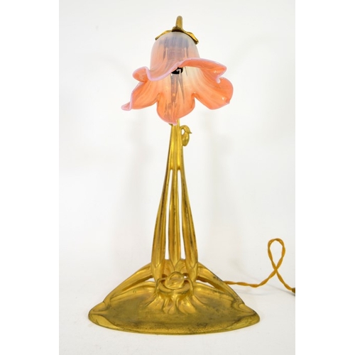 248 - An Art Nouveau gilt bronze desk lamp, circa 1900, in the form of a flower, the sinuous three tendril... 